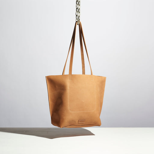 tan leather purse with medium length straps made by hand in portland maine