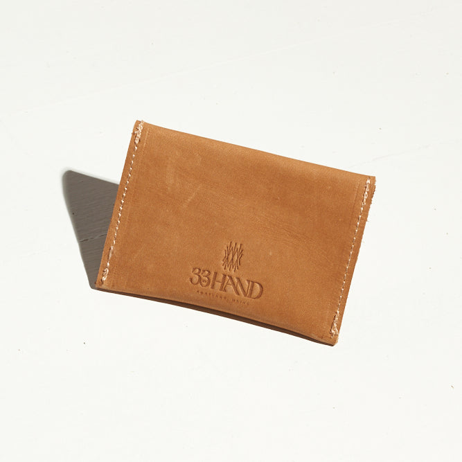 small, sleek tan leather card wallet