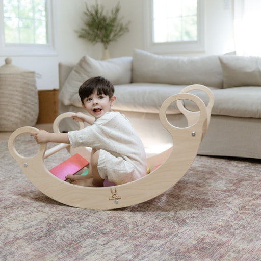 Child playing on a rocker climber arch