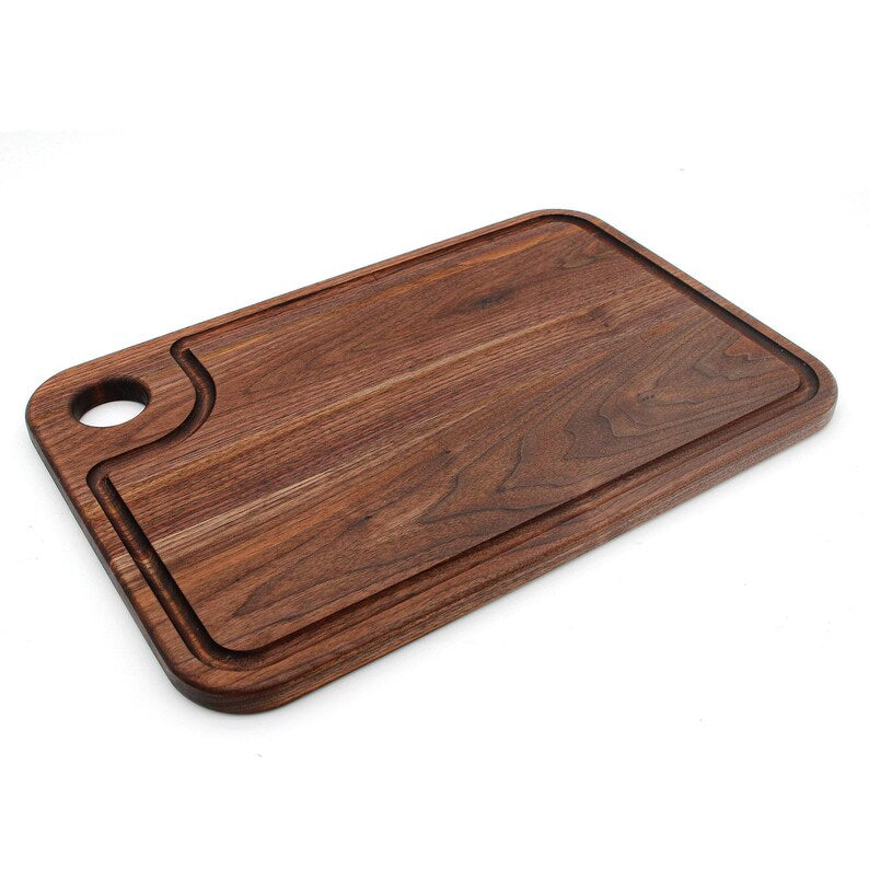 Overhead view of a walnut pizza peel with a long built-in handle
