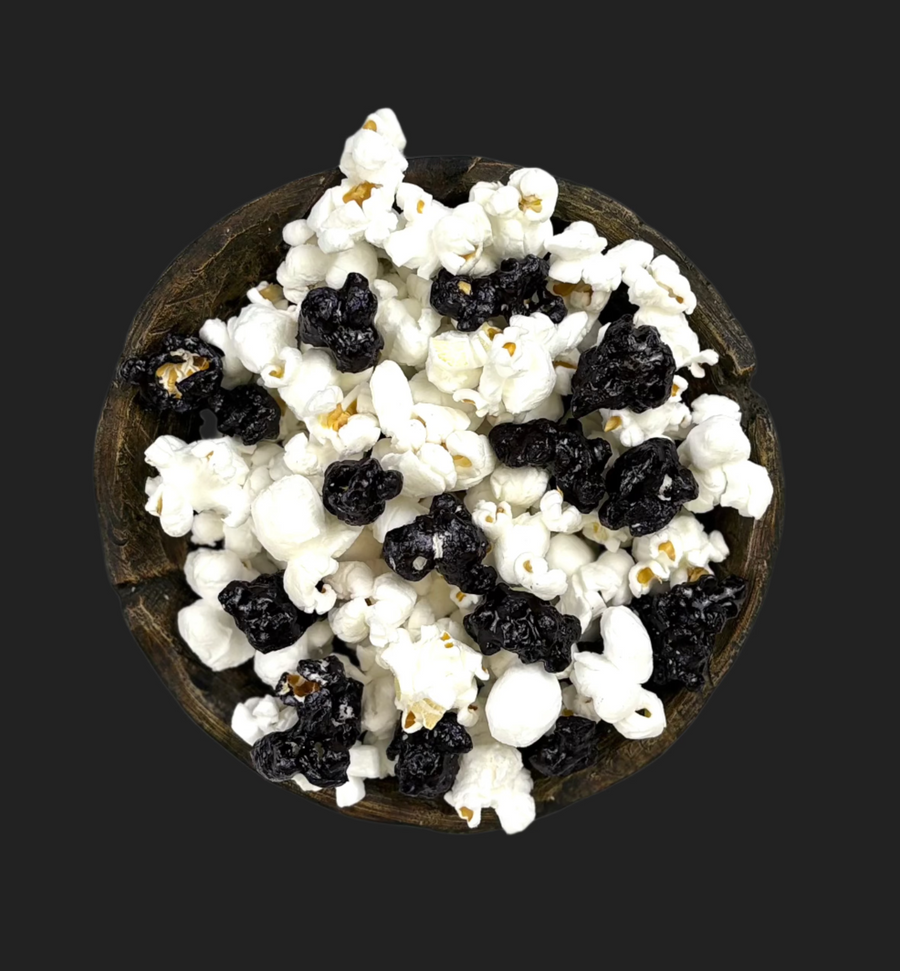 Bowl of black & white candy-coated and white salted popcorn