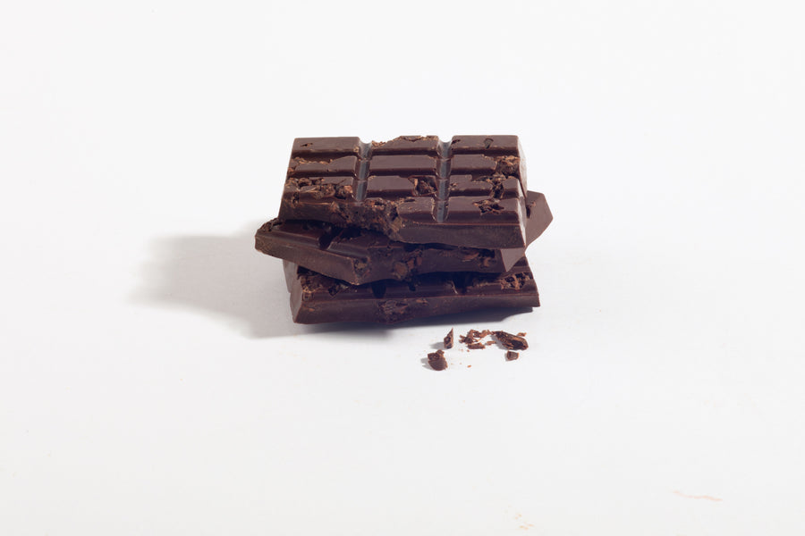 Stacked pieces of Caramelized Cocoa Nib Dark Chocolate Bar