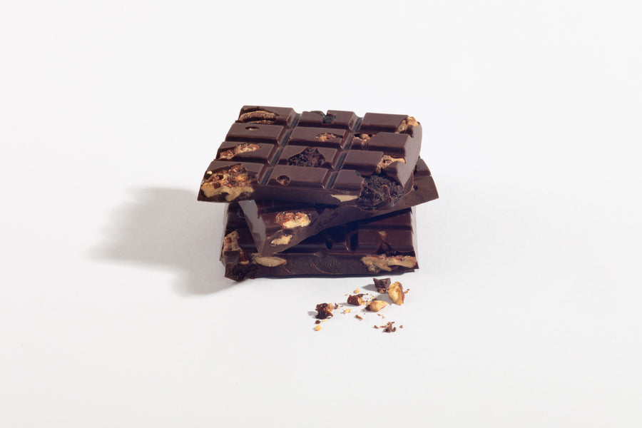 Stacked pieces of Salted Pecan & Cherry Dark Chocolate Bar