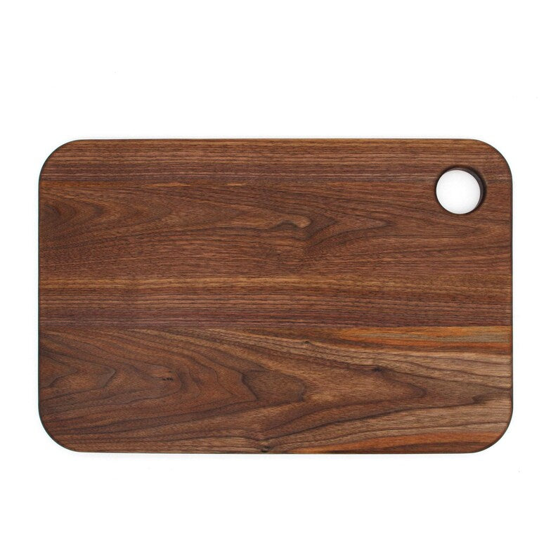 Plain reverse surface of a walnut thumb-hole cutting board