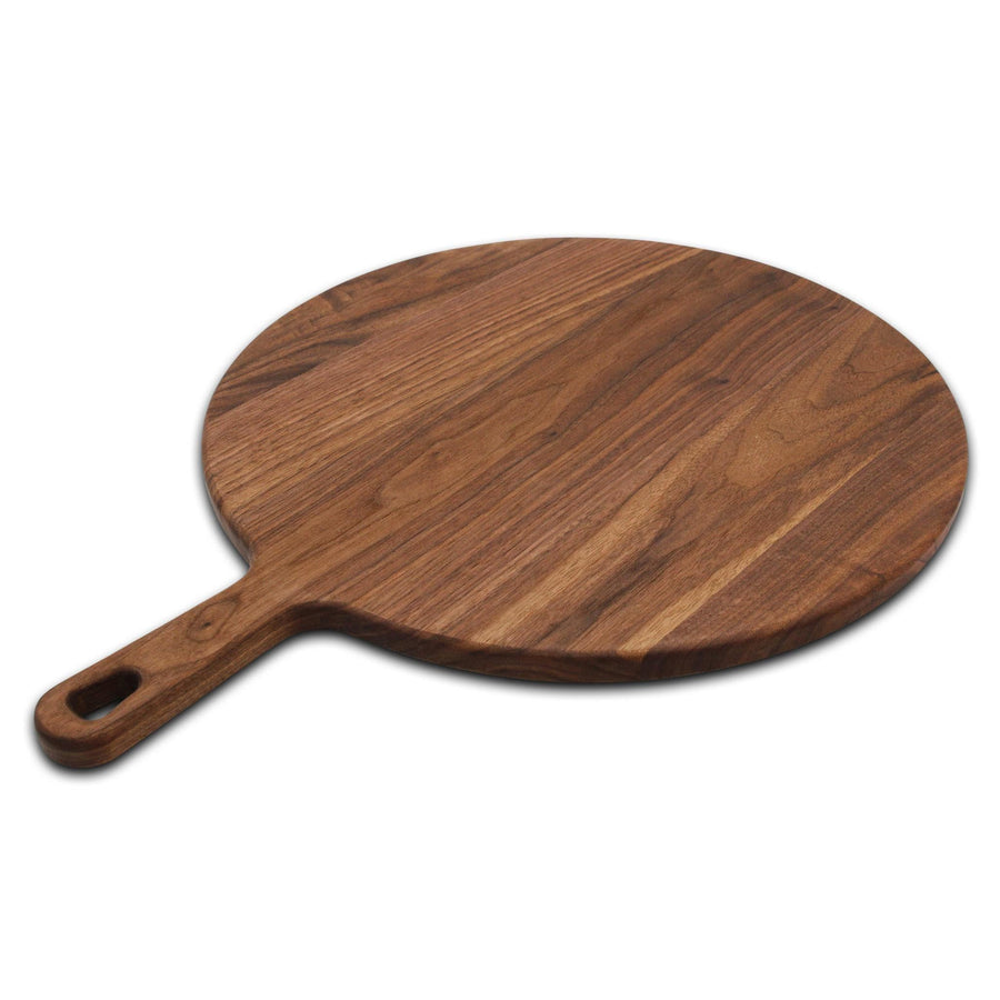 Round walnut serving paddle photographed from an angle
