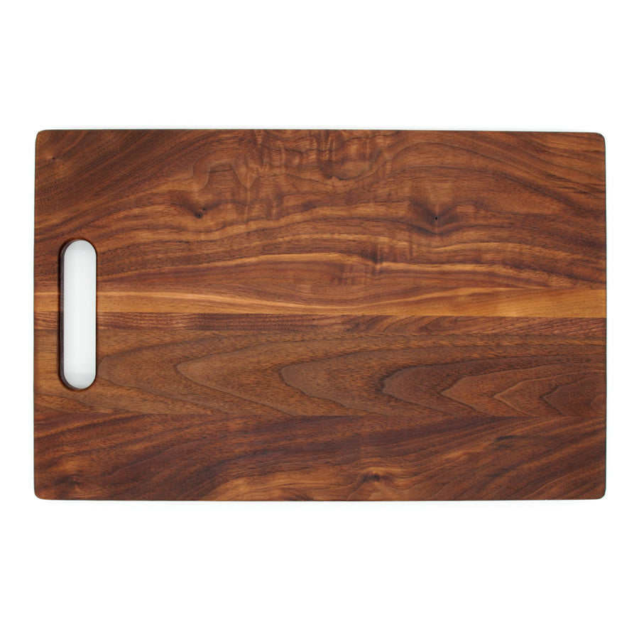 Overhead view of a walnut board with one cutout handle