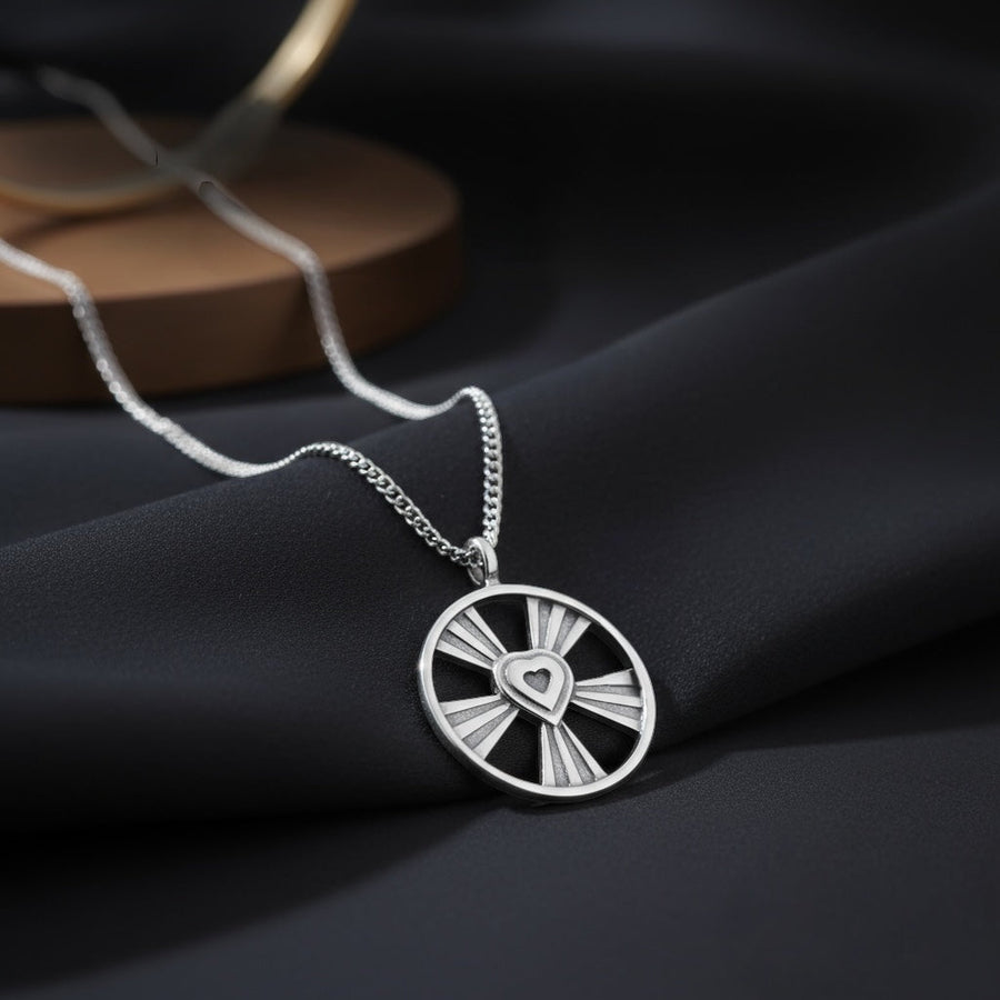 Shining Heart necklace arranged against a dark background
