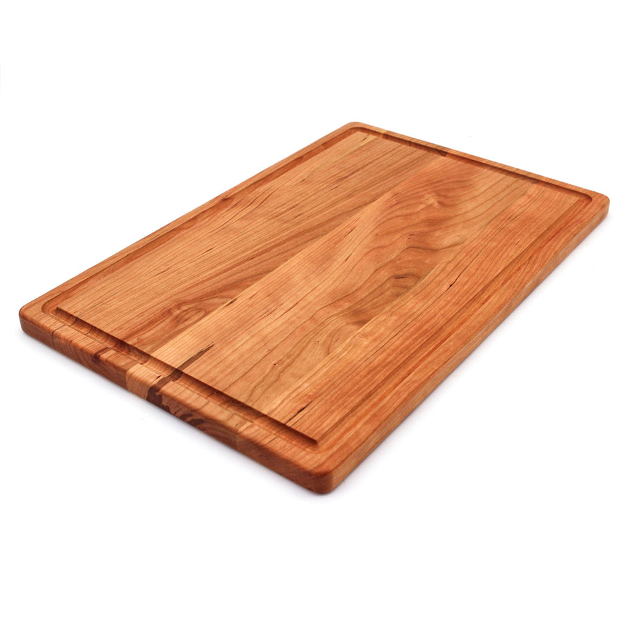 Cherry cutting board with a juice groove, angled view