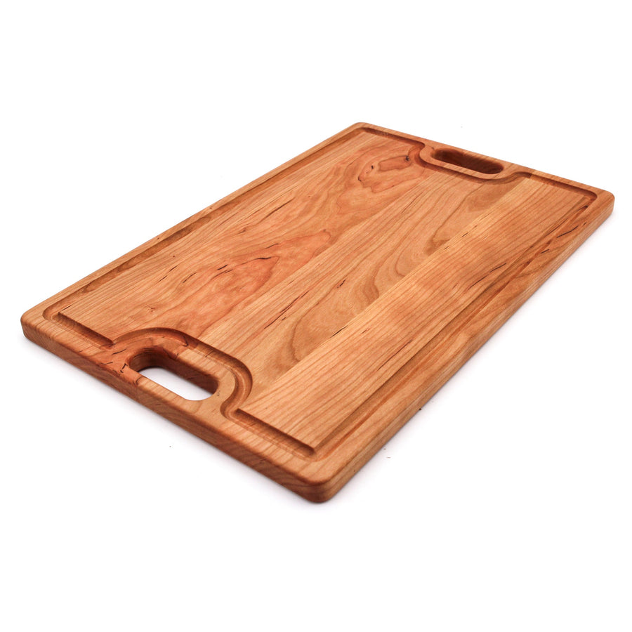 Cherry board with two cutout handles and a shaped groove