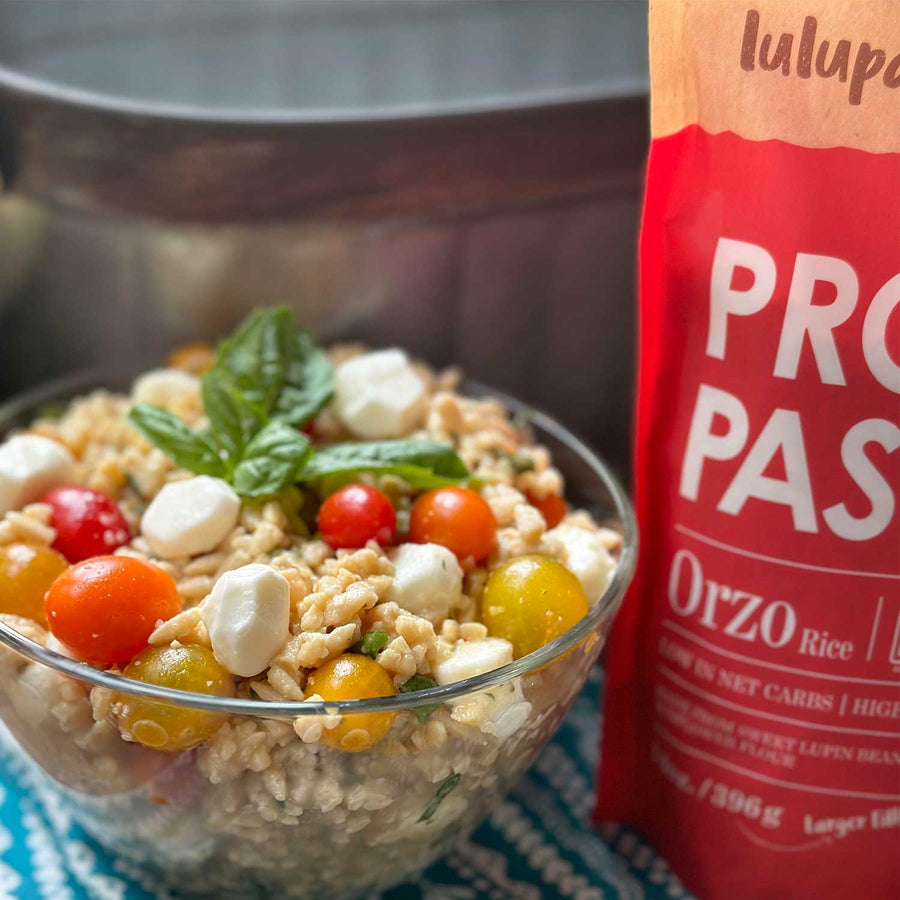 Lupin & Sunflower Protein Orzo Pasta: pouch beside prepared orzo salad.