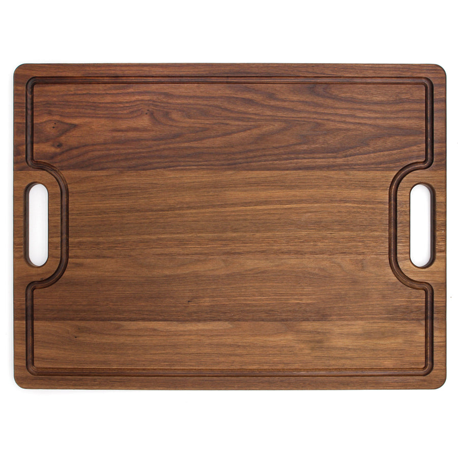 Walnut board with cutout handles and a shaped perimeter groove