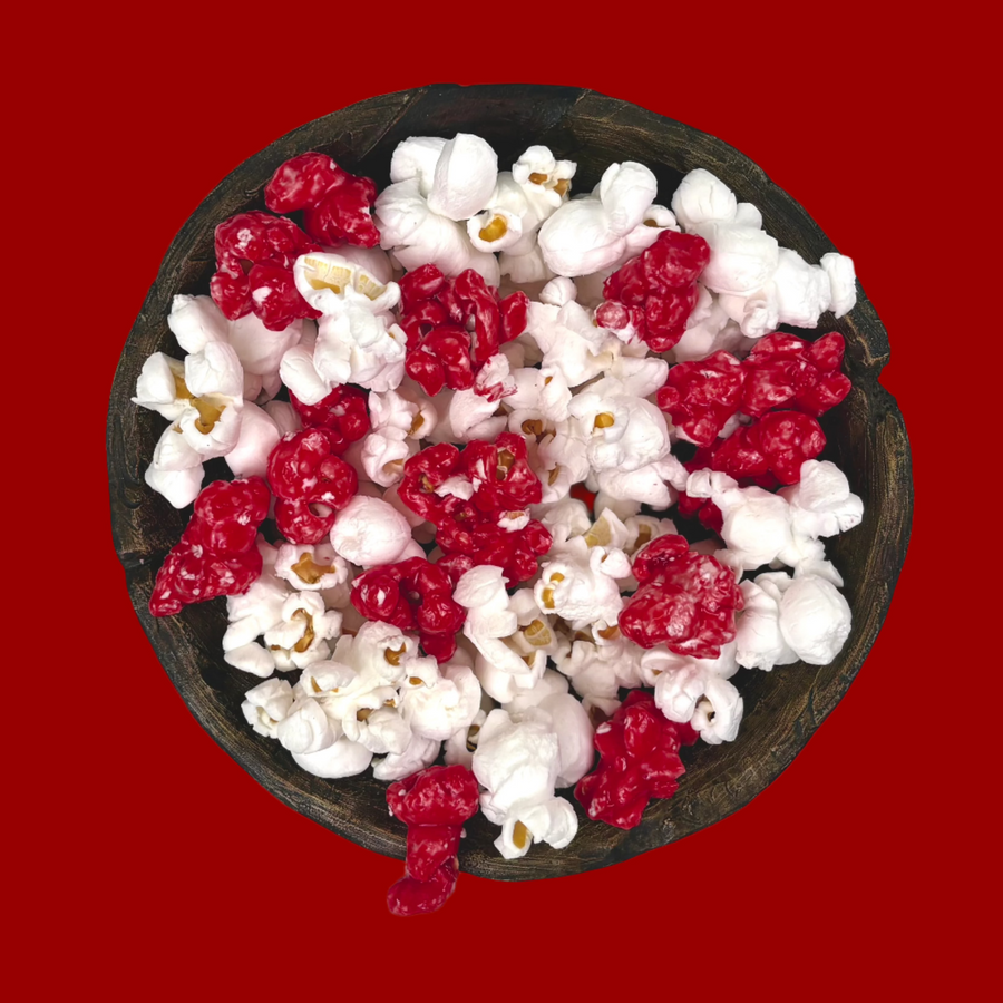 Bowl of dark red candy-coated and white salted popcorn