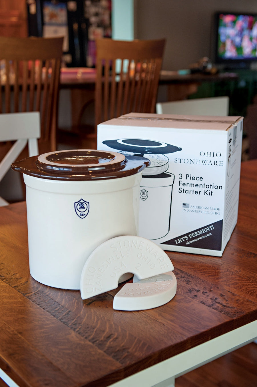 Boxed two-gallon crock starter kit displayed with its ceramic accessories