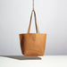tan leather purse with medium length straps made by hand in portland maine