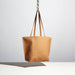 tan leather purse with medium length straps made by hand in portland maine