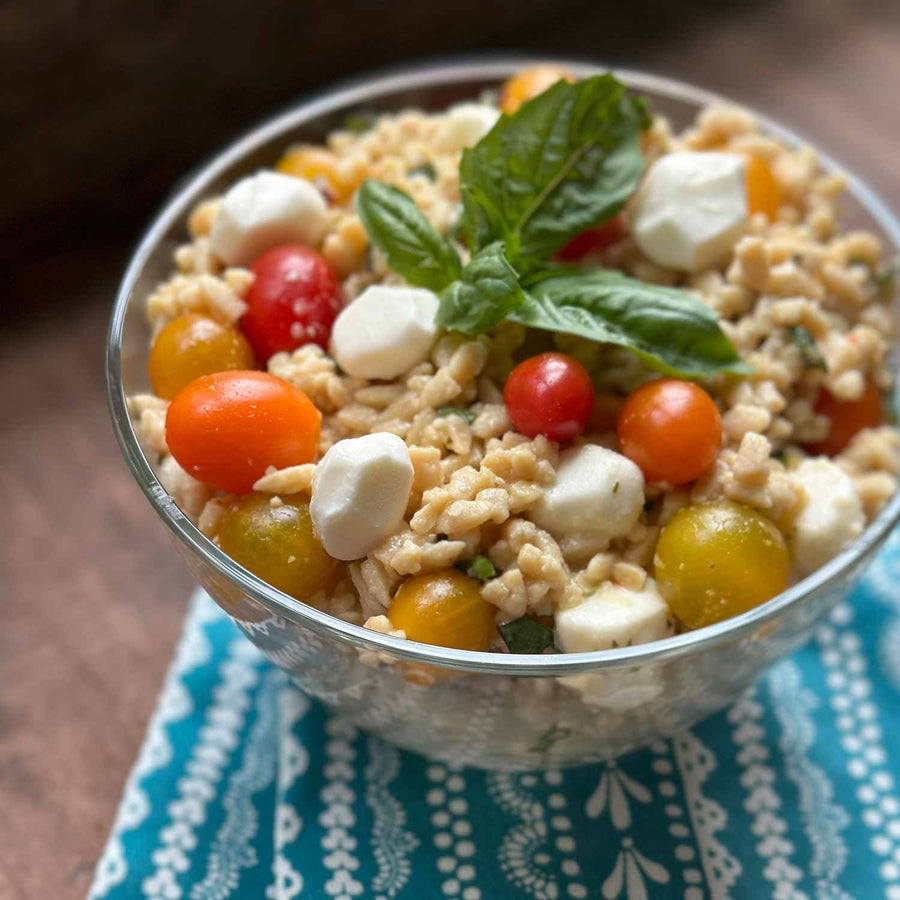 Lupin & Sunflower Protein Orzo Pasta: prepared orzo salad in a glass bowl.