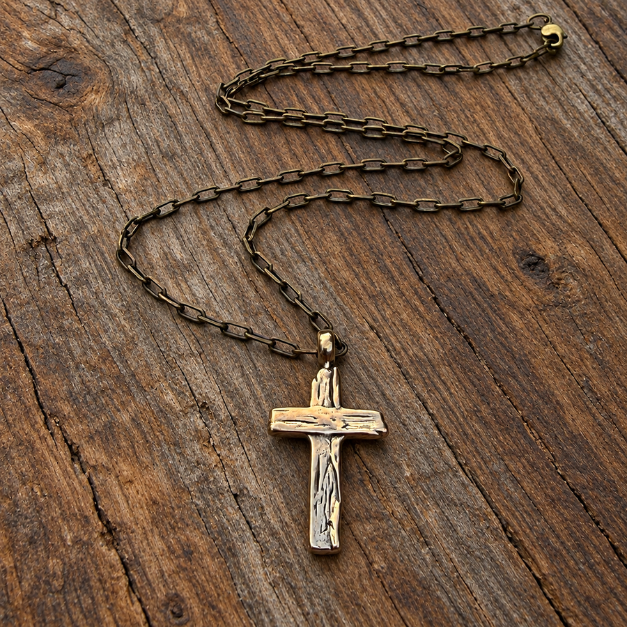 Weathered Cross necklace and cable chain on wood