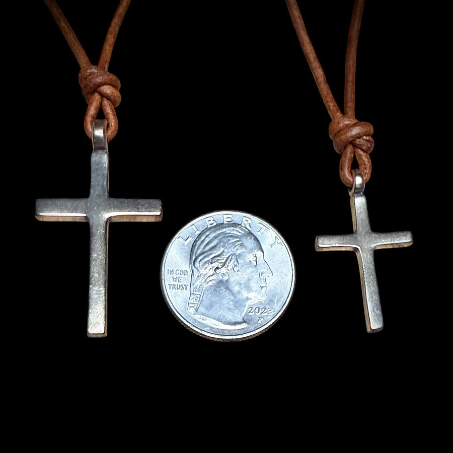 Large and medium Classic Cross pendants compared beside a coin