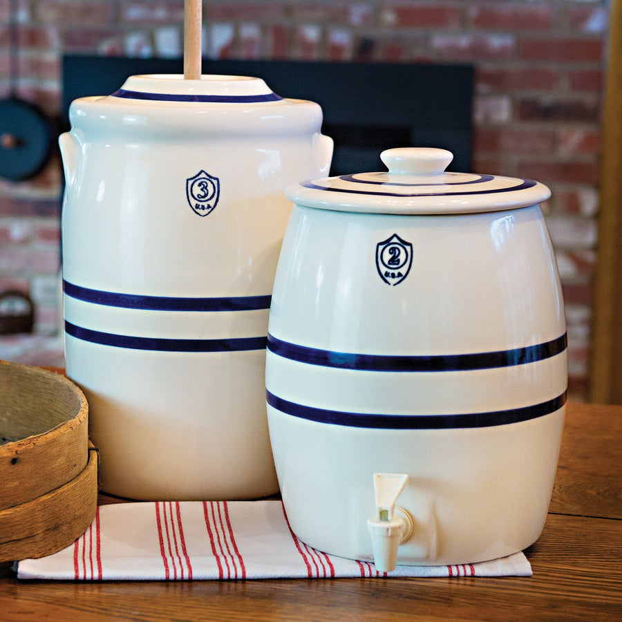 Blue-striped churn and beverage keg in a styled display; wooden dasher and tap are separate
