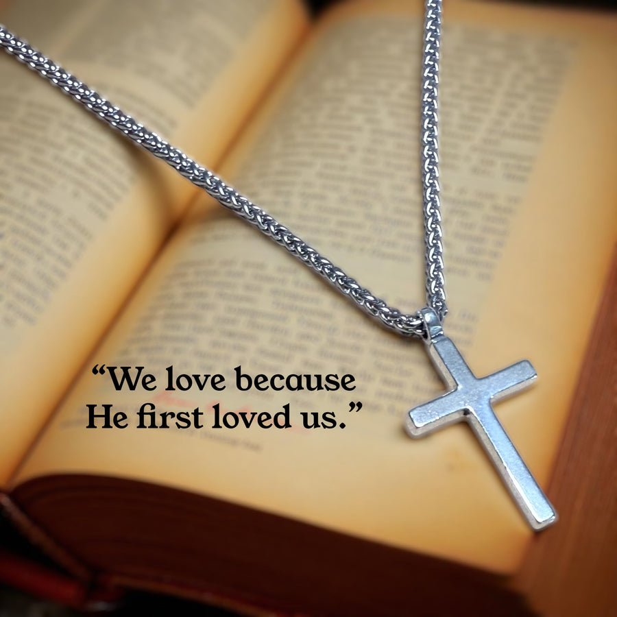 Classic Cross necklace resting on an open book
