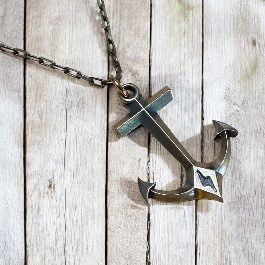 Large anchor pendant and cable chain against wood