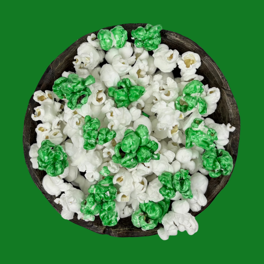 Bowl of green candy-coated and white salted popcorn