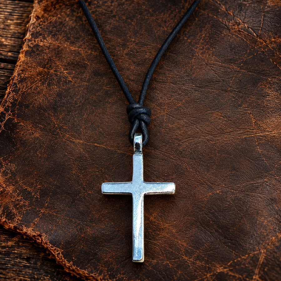 Classic cross pendant against reddish stone