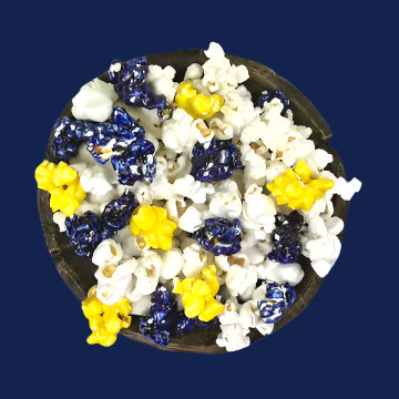 Bowl of dark blue & yellow candy-coated and white salted popcorn