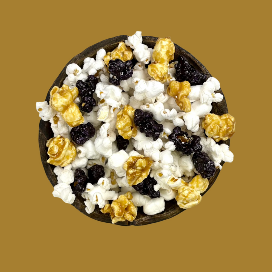 Bowl of black, gold and white popcorn mix
