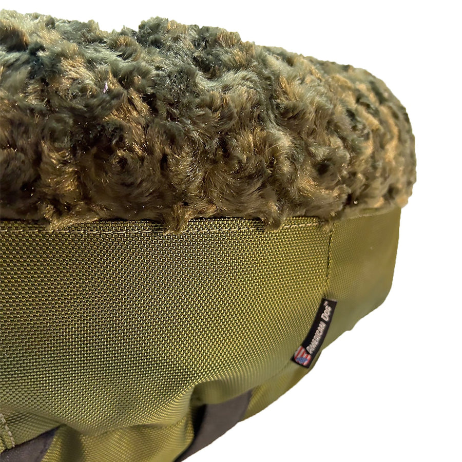Close-up of olive fleece and side panel on a Furvana round dog bed