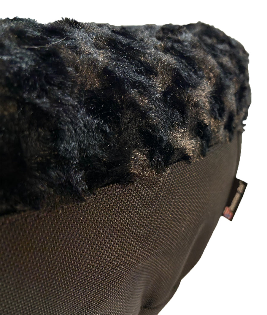 Close-up of black fleece and side panel on a Furvana round dog bed