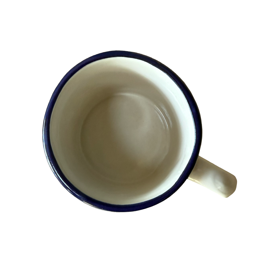 Top view of anniversary mug showing light glazed interior and blue rim