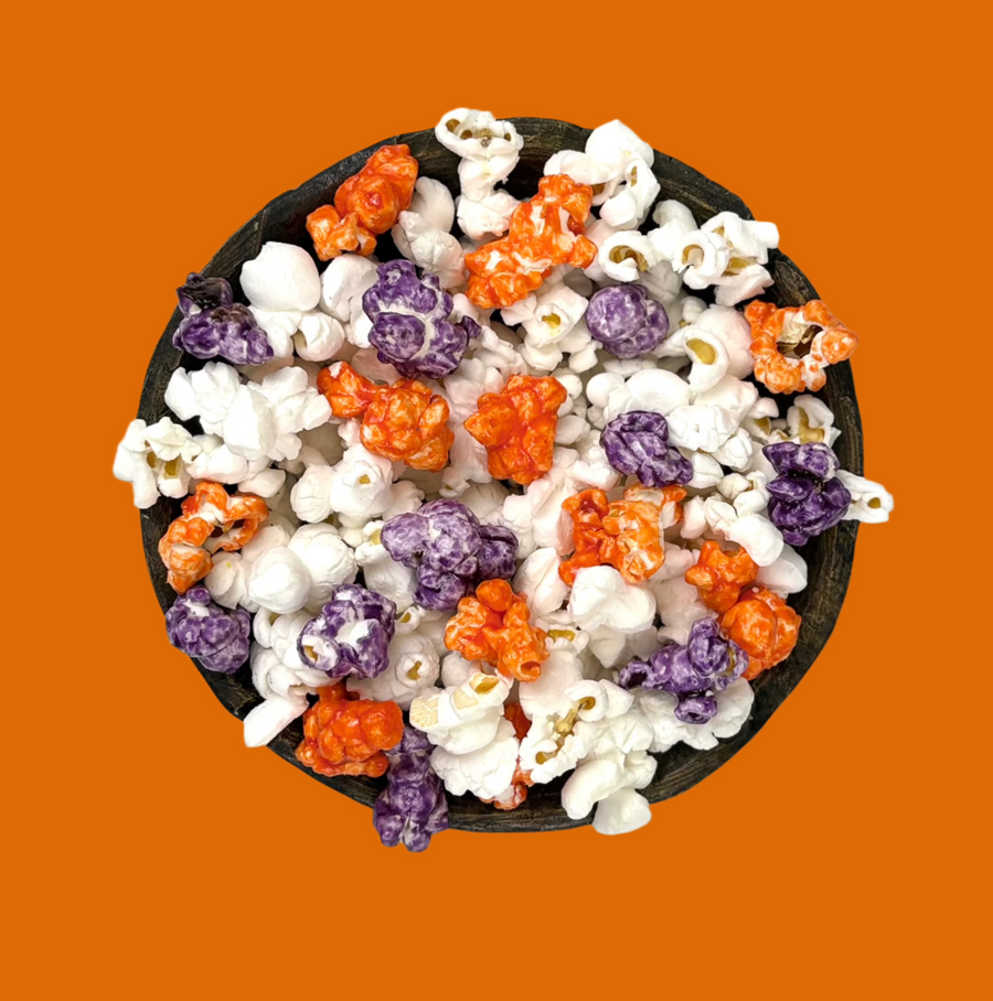 Bowl of orange & purple candy-coated and white salted popcorn