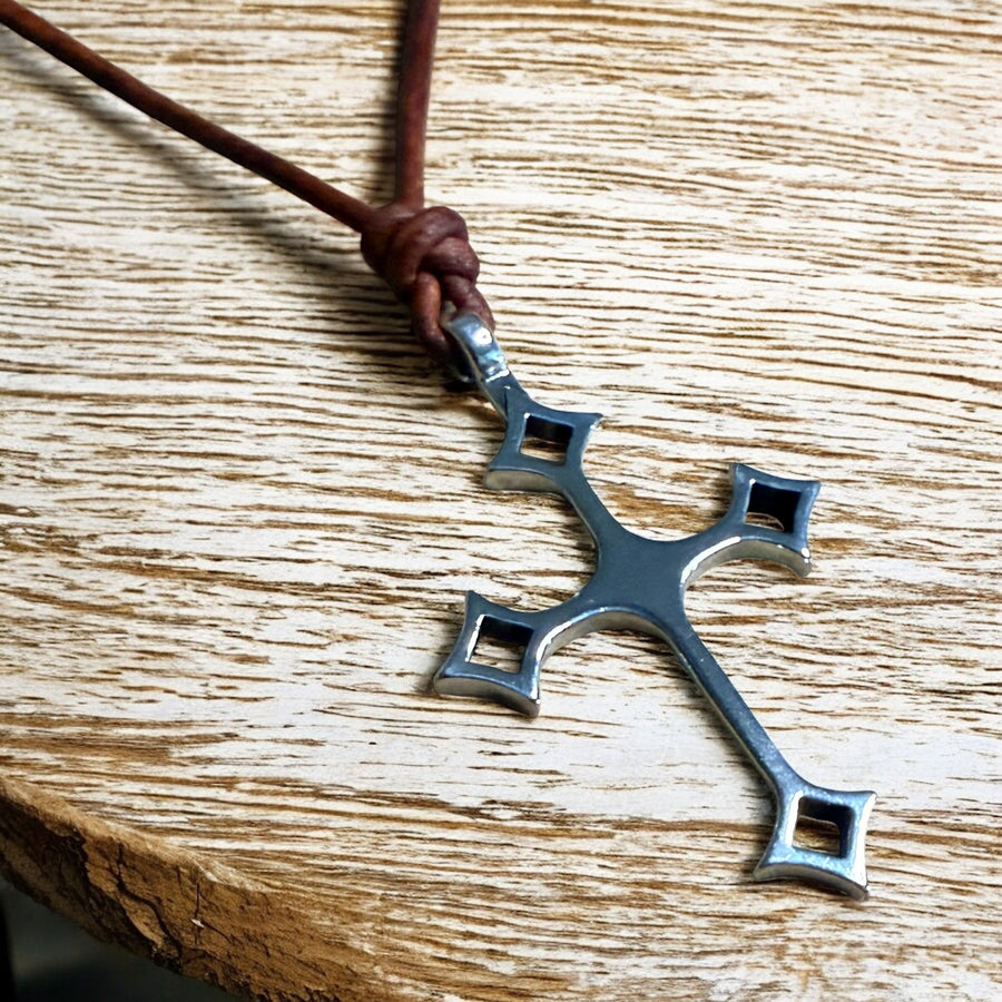 Close view of Gothic cross and knotted brown cord
