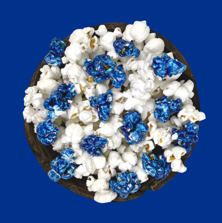 Bowl of blue candy-coated and white salted popcorn