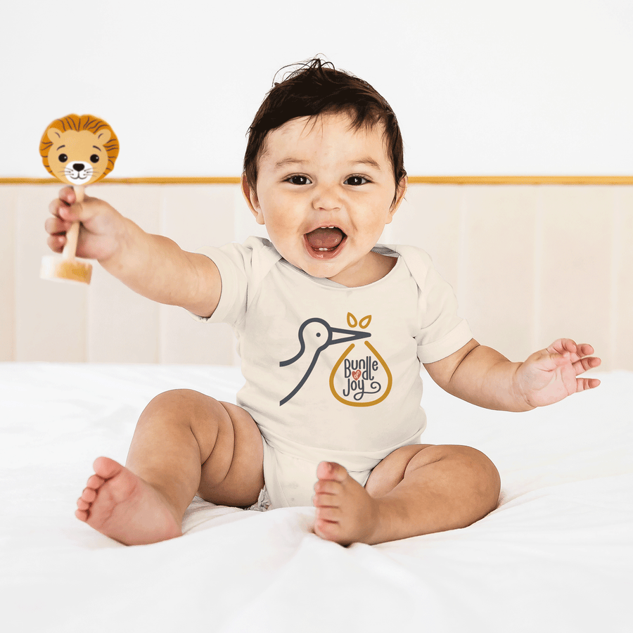 Baby wearing a cream Bundle of Joy cotton bodysuit and holding a toy