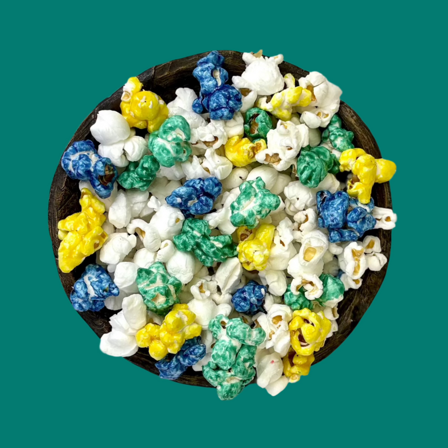 Bowl of teal, yellow & blue candy-coated and white salted popcorn