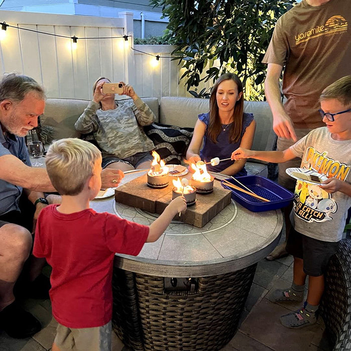 Family gathered outdoors around a portable bonfire