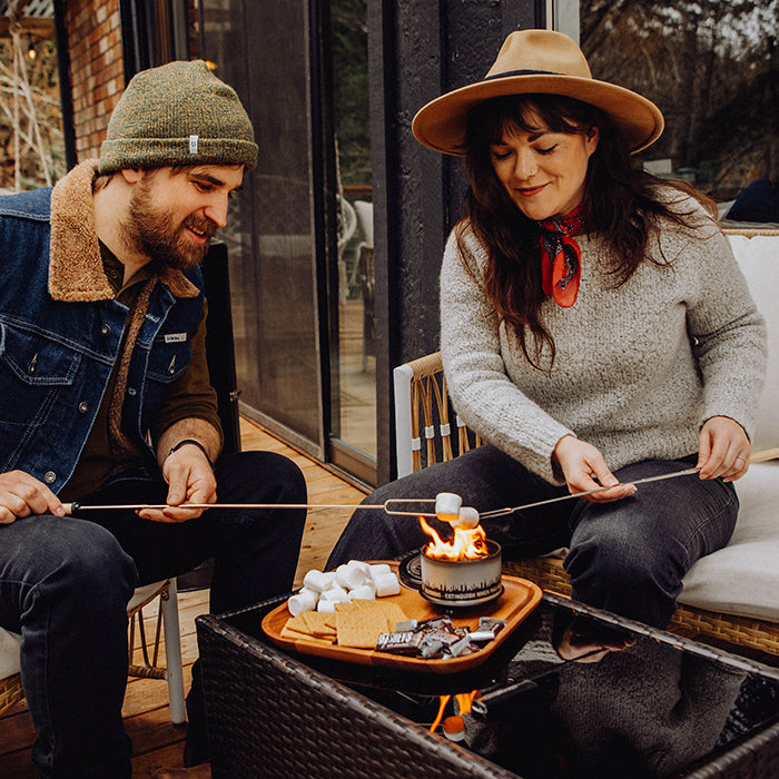 Two people enjoying a bonfire in an outdoor seating area
