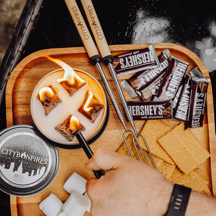 Bonfire and lid beside chocolate, marshmallows and graham crackers