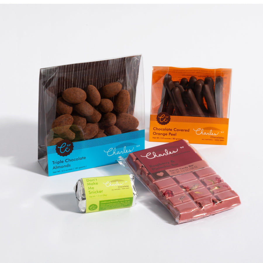 Four-product chocolate starter sampler with coated almonds, citrus peel, and two chocolate bars