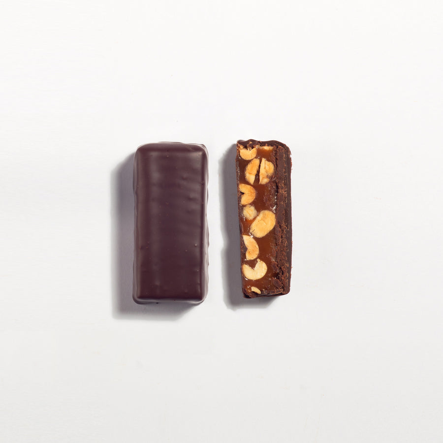 Peanut Caramel & Dark Chocolate Ganache Bar cut open to show the filling