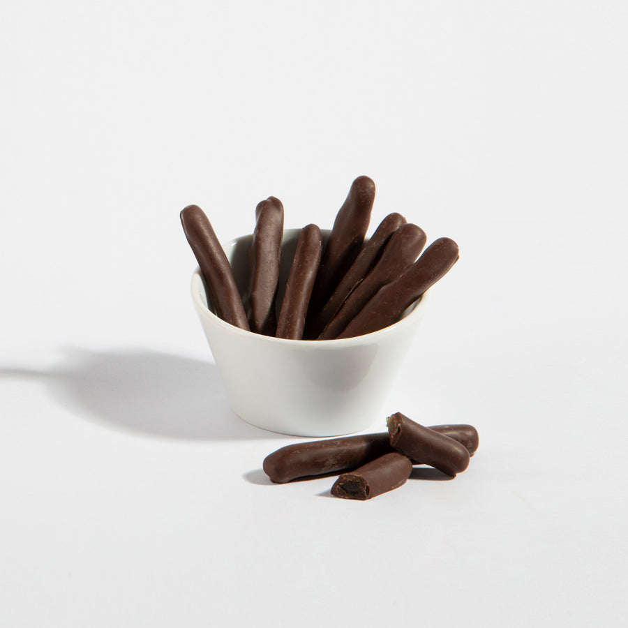 Dark chocolate-covered lemon peel strips in a white serving bowl