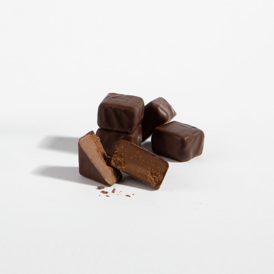 Chocolate-coated Gianduja blocks in a small pile