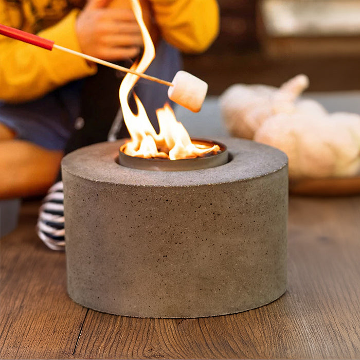 Marshmallows roasting over a bonfire in the cylinder concrete holder
