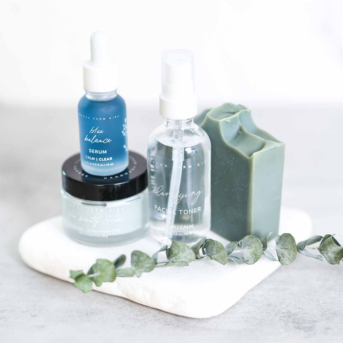 Clear and Calm kit products on a white tray with foliage