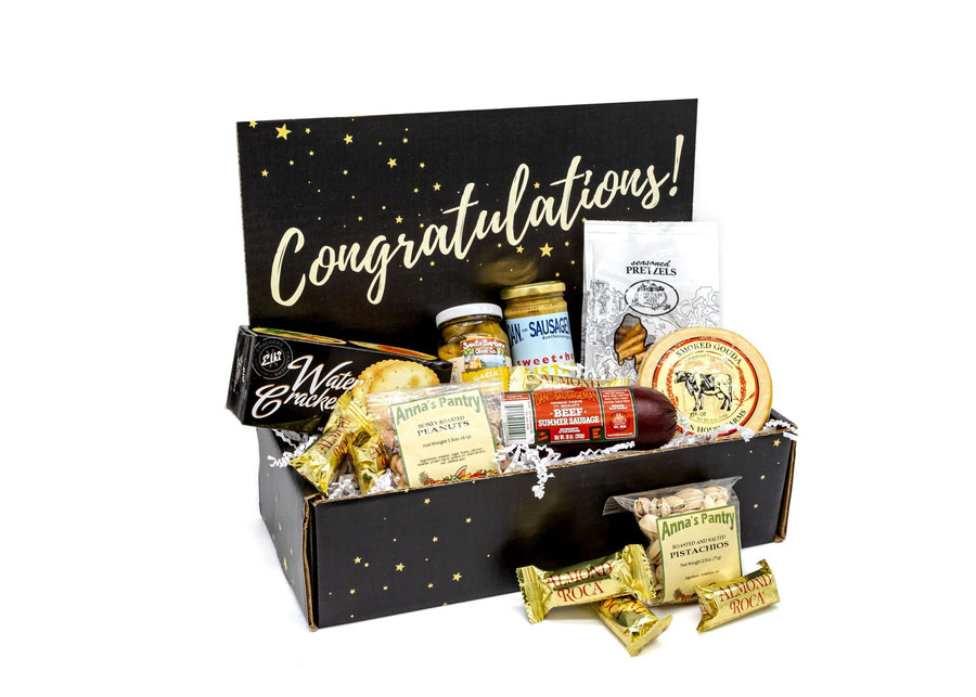 Open Congratulations gift box with individually packed foods and wrapped candy