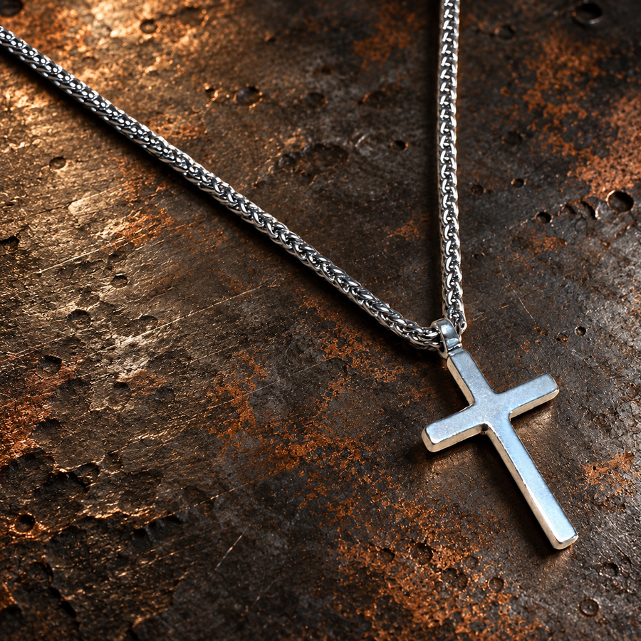 Classic Cross pendant and chain against dark stone