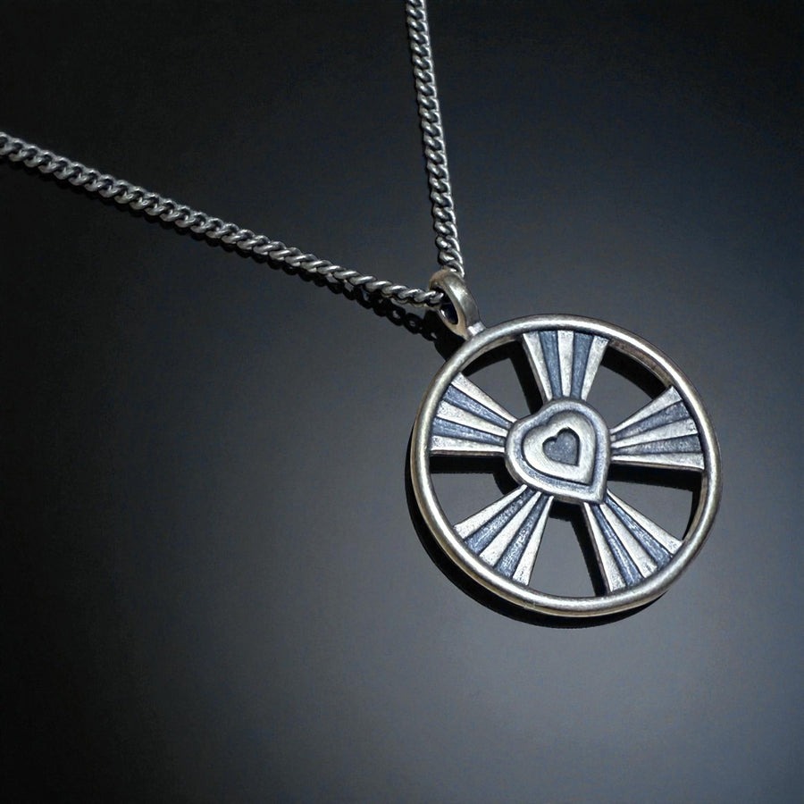 Shining Heart pendant and chain against a dark background