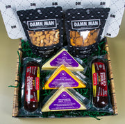 Gourmet gift basket with snacks and cheese in a decorative box.